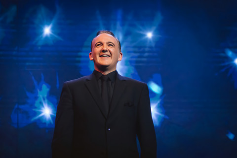 Norbert Ferré smiling on stage.